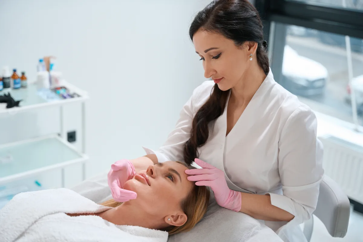 Esthetician performing a facial treatment on a client